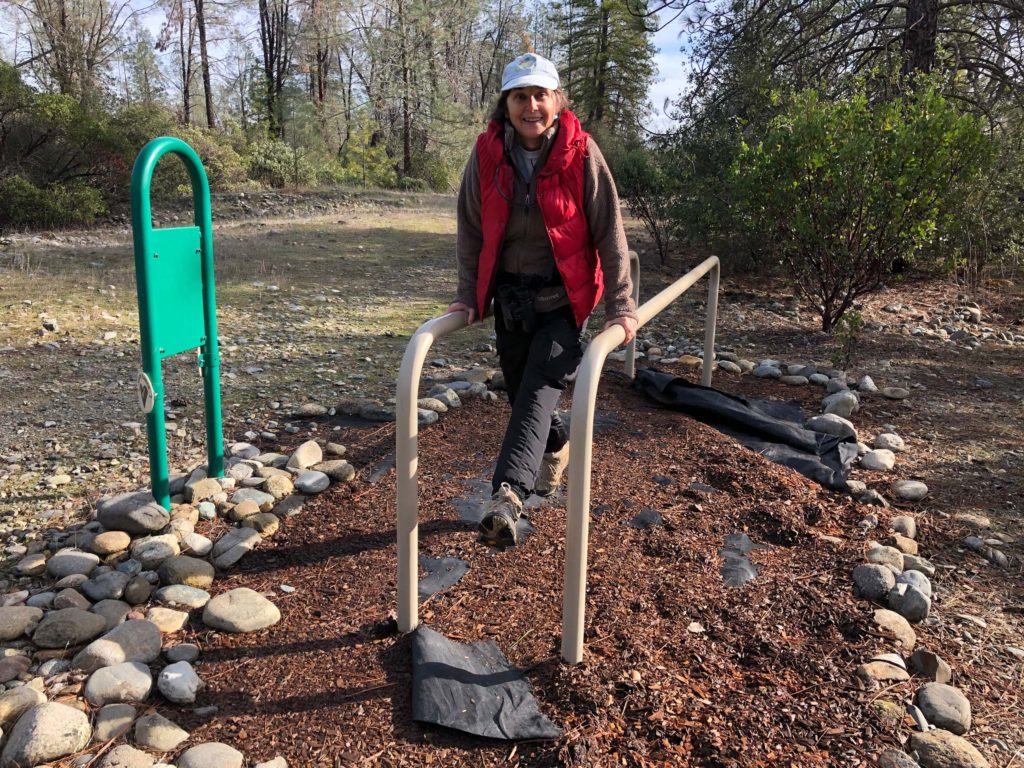 Paula demonstrates exercise equipment on the Clear Creek Gorge trail, Jan. 18, 20202. Photo by Chris Harvey.