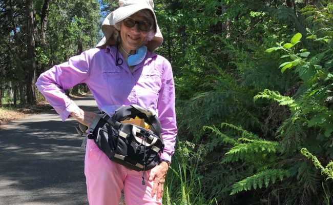 Marti Weidert, with white-flowered bog orchid and giant chain fern. S. Libonati-Barnes.