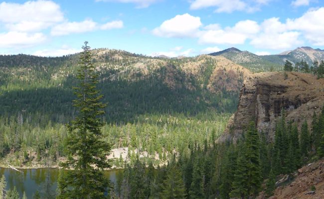 Panortama of Cemembnt Bluff & distant mountains, Bluff Lake. D. Burk