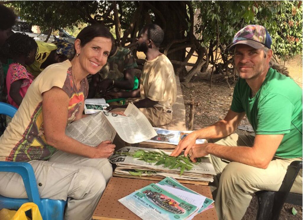 Susannah & husband pressing plants in Senegal. S. Fulton.