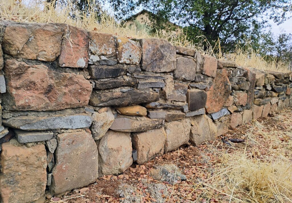 Stone retaining wall. D. Ledger.