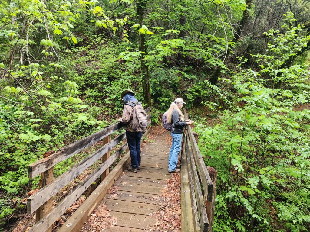 Dave & Laurie on Hirz Bay Trail bridge. D. Burk.