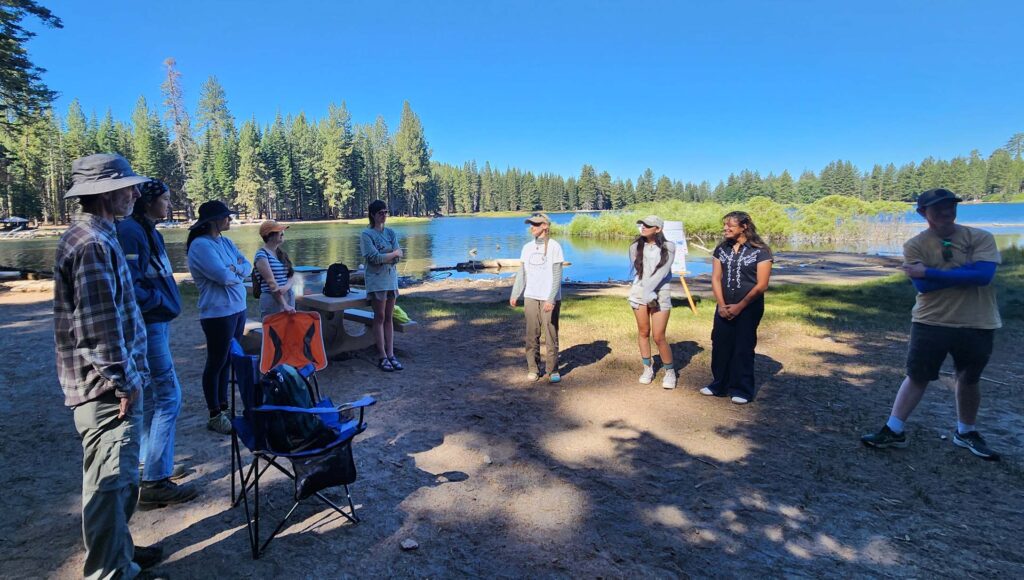A group of attendees make introductions at Manzanita Lake. Photo © Juliet Malik. July 20, 2025. LVNP.