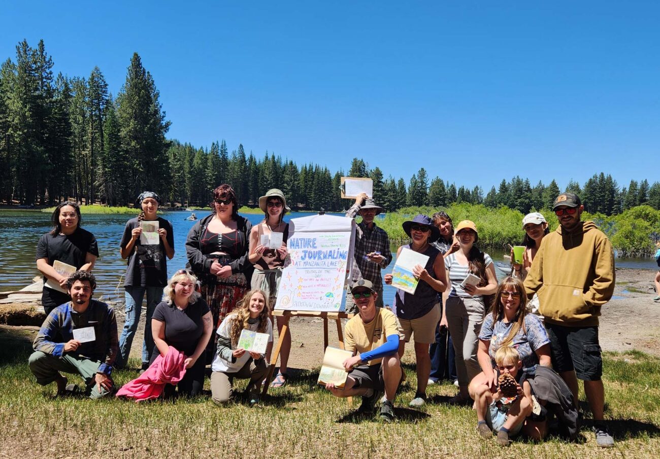 Journaling attendees show their full notebooks of observations at Manzanita Lake. Photo © J. Malik. July 20, 2025.