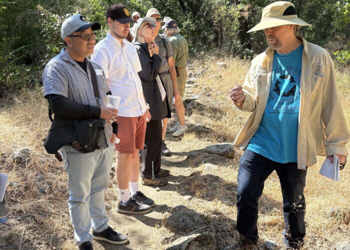 David Ledger speaks to picnic attendees on the trail. Photo by J. Kelley.