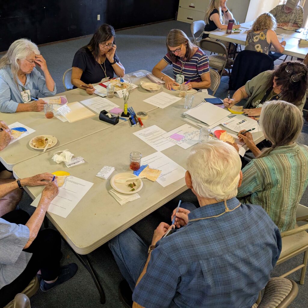 Moving Forward Together meeting participants writing on their mushrooms. July 22, 2025. R. Redlich. WSRCD office, Anderson.