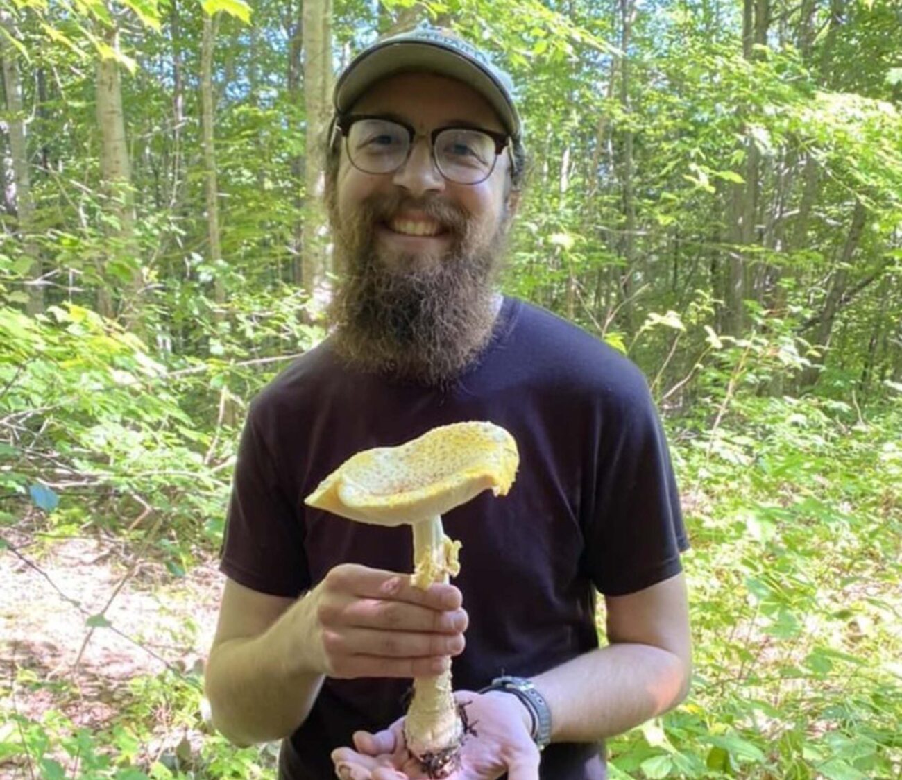 Josh Willems, previous scholarship awardee, with a yellow fly agaric in the White Mountains of New Hampshire. Photo provided by C. Willems.